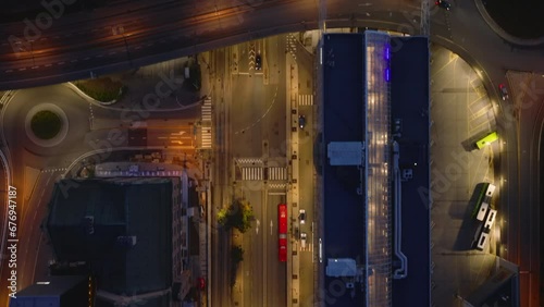 Birds eye shot of streets and buildings in evening city. Illuminated road and modern town development. Oslo, Norway photo