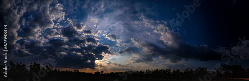 Panorama of the night sky with clouds and stars
