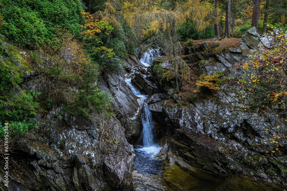Landscape of Falls of Bruar Waterfall with mossy rocks in Scotland