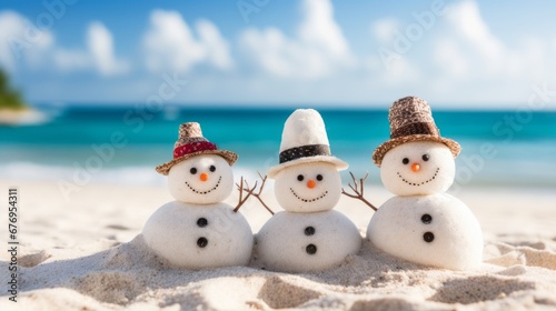 a family of snowman made from sand on a tropical beach photo