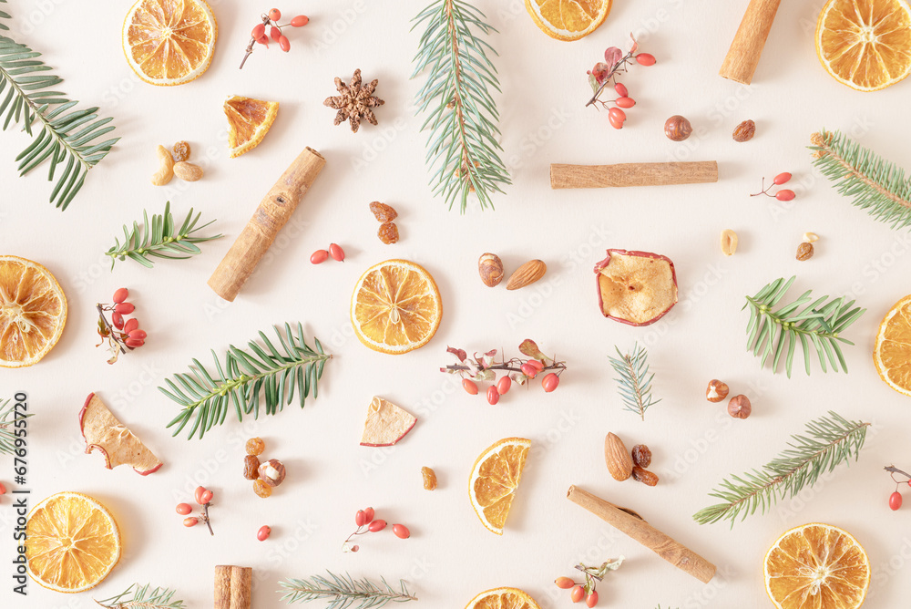 Christmas background made of natural branches, dry oranges fruits, anise, nuts, apple and cinnamon on a cream background. Holiday wallpaper nature concept. Christmas background made of natural branches, dry oranges fruits, anise, nuts, apple and cinnamon on a cream background. Holiday wallpaper nature concept.