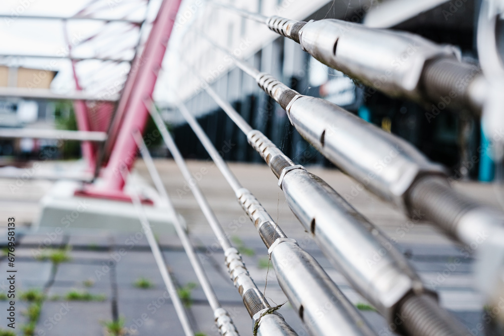 Steel stays attached to a support driven into the ground hold the steel cables of a bridge. Steel stays attached to a support driven into the ground hold the steel cables of a bridge.