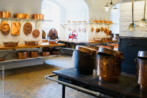 Vintage culinary artifacts and antique cookware are showcased in a historical kitchen exhibition from bygone eras