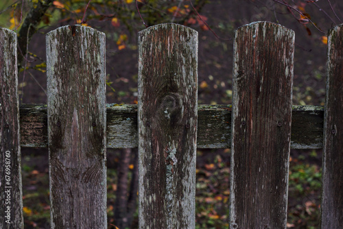 horizontal image with old wooden rustic fence in counryside autumn garden photo