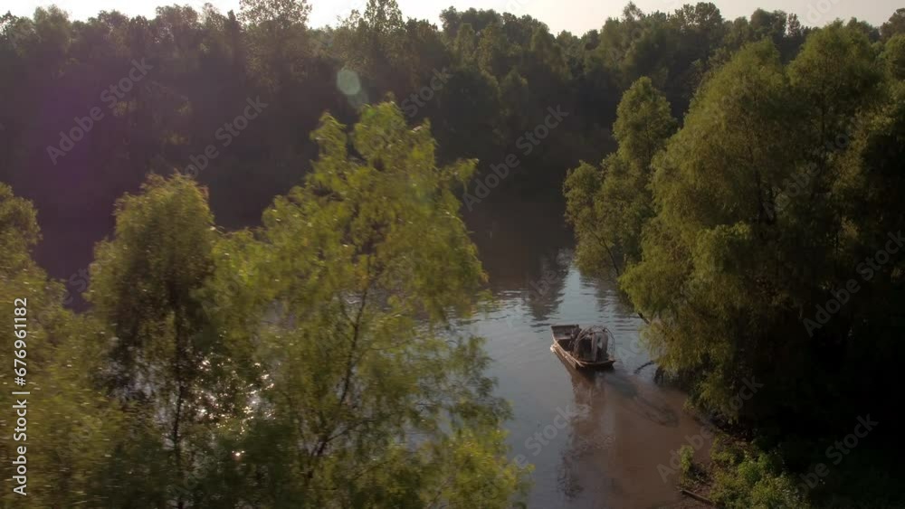 Aerial Panning Shot Of Motorboat And Airboat In Atchafalaya River, Drone Flying Over Trees - Bayou, Louisiana Aerial Panning Shot Of Motorboat And Airboat In Atchafalaya River, Drone Flying Over Trees - Bayou, Louisiana