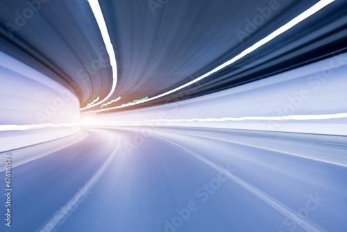 Motion blur shot of an empty road under a tunnel with white lights