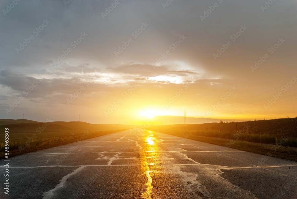 Empty road leading to the sunset