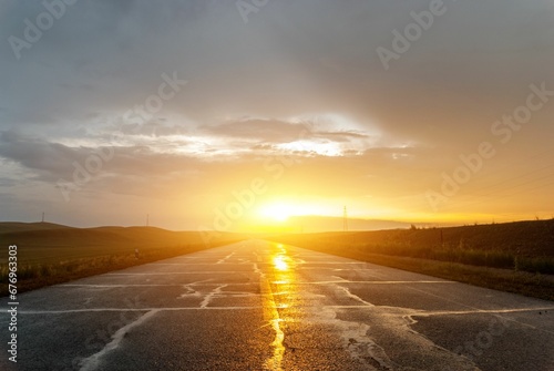Empty road leading to the sunset