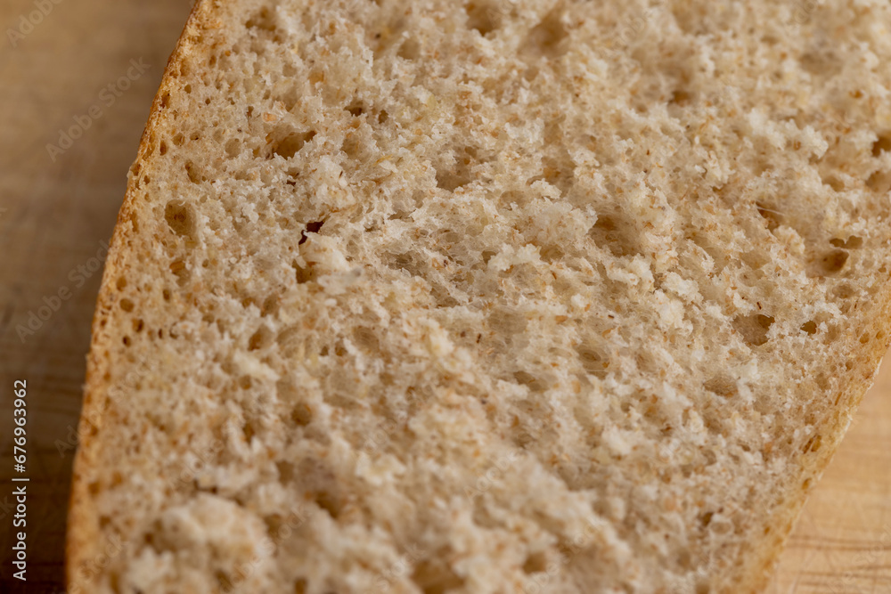 fresh wheat bread with bran on the cutting board