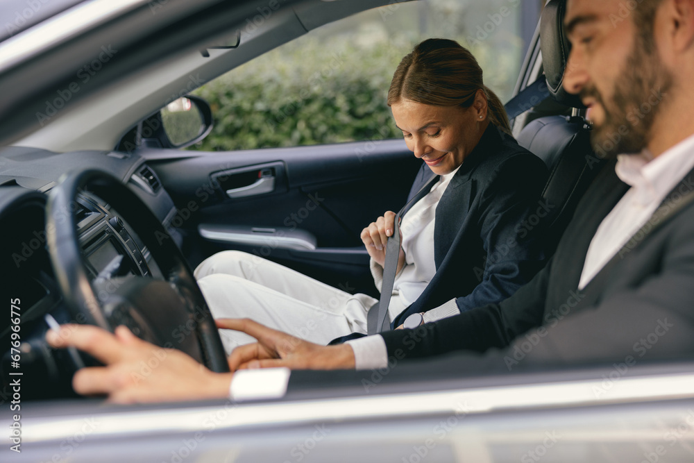 Two positive business colleagues in suit carpooling journey into work together Two positive business colleagues in suit carpooling journey into work together