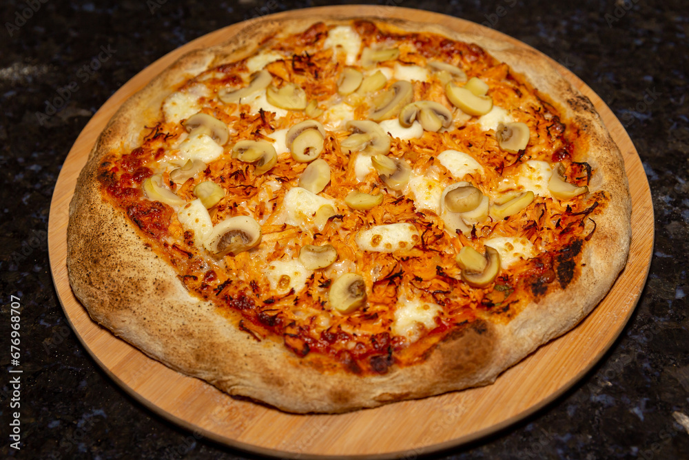 Traditional Brazilian chicken pizza with catupiry cheese and mushrooms