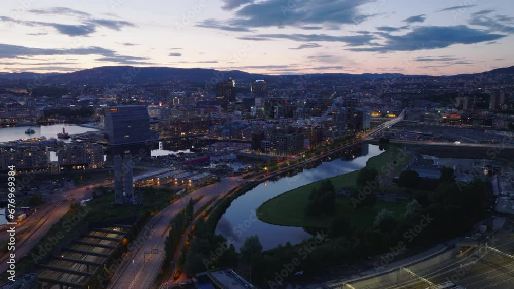 Forwards fly above city at dusk. Streets and modern town development and water surface reflecting twilight sky. Oslo, Norway Forwards fly above city at dusk. Streets and modern town development and water surface reflecting twilight sky. Oslo, Norway