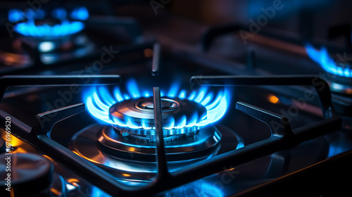 Blue flames of a gas burner on a kitchen stove in the dark