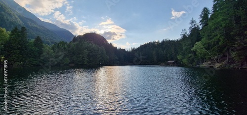  Nestled amid the picturesque landscapes of the Austrian Alps, Lake Piburg enchants with its crystal-clear waters and scenic surroundings. Surrounded by lush forests and majestic mountains, the lake r photo