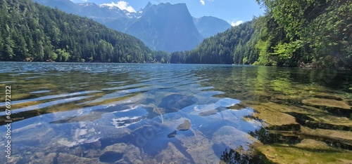  Nestled amid the picturesque landscapes of the Austrian Alps, Lake Piburg enchants with its crystal-clear waters and scenic surroundings. Surrounded by lush forests and majestic mountains, the lake r photo