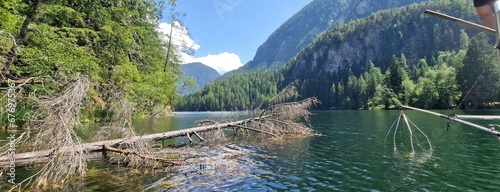 Nestled amid the picturesque landscapes of the Austrian Alps, Lake Piburg enchants with its crystal-clear waters and scenic surroundings. Surrounded by lush forests and majestic mountains, the lake  photo