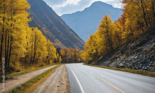 Road near mountain river in autumn