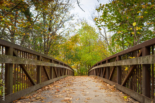 Canvas Print Old footpath bridge close-up view on an autumn day, Charles River Greenway, Wate