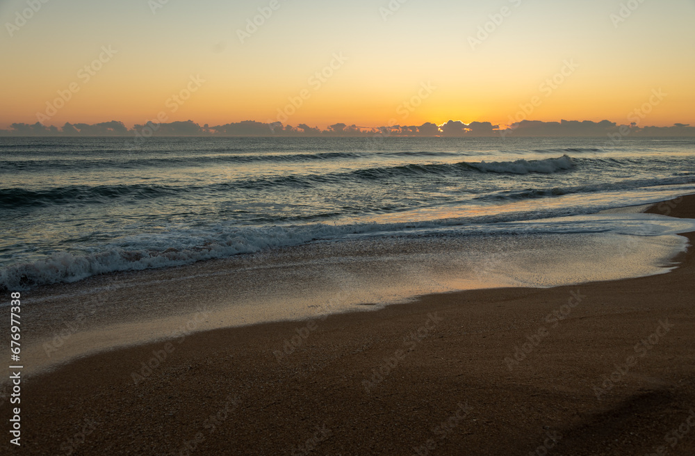 Crashing waves during golden hour at sunrise on Florida beach