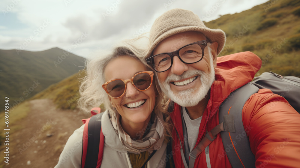 An elderly couple enjoying their hiking trip vacation, taking a selfy during a short break 