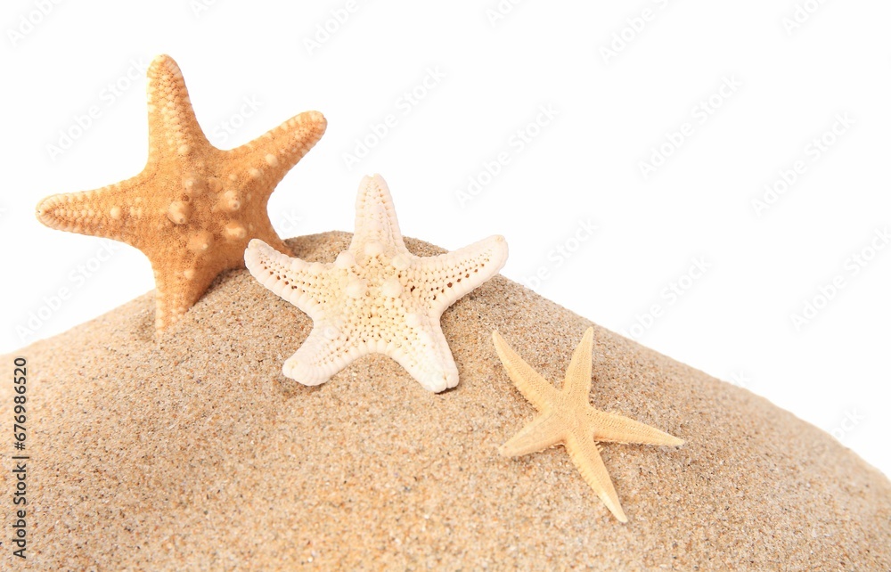 Sand with many beautiful sea stars isolated on white Sand with many beautiful sea stars isolated on white
