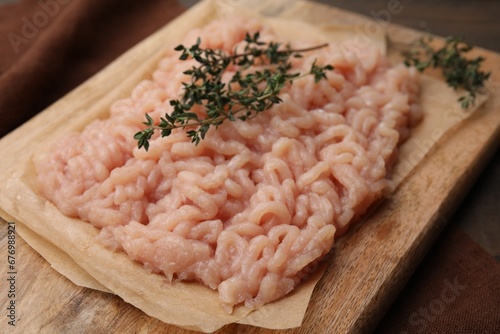 Fresh raw minced meat and thyme on table, closeup