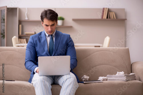 Young male employee working from home during pandemic