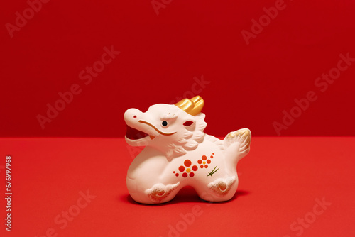 Japanese new year material. Zodiac dragon on red background. 日本のお正月素材。赤色背景上の干支の辰。 © Kana Design Image