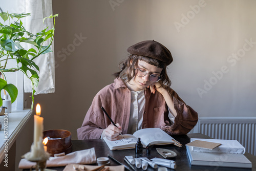 Animated cartoon artist sketching with ink in cozy studio. Serious tired girl in glasses, vintage clothes, beret creating animation. Hobby, creative pastime, freelance work, professional occupation