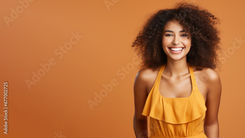 Afro-american woman model wearing a orange sundress isolated on pastel