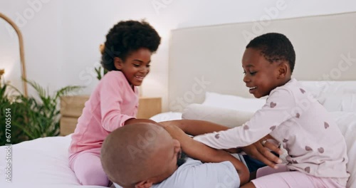 Black family, bedroom and children tickling their father in the morning at their home together for fun. Love, smile and kids in bed with their man parent for bonding or to wake up on the weekend photo