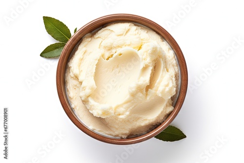 Top view of a bowl with isolated shea butter on a white background photo