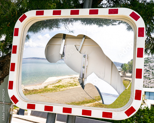 Broken road mirror near the mediterranean sea