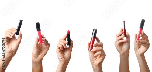 Many women s hands holding color lipsticks on white background