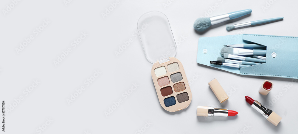 Set of decorative cosmetics on light background with space for text Set of decorative cosmetics on light background with space for text