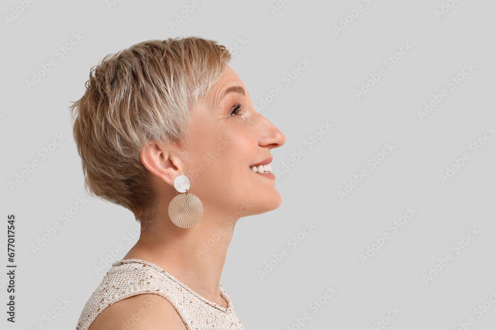 Mature blonde woman on light background, closeup Mature blonde woman on light background, closeup