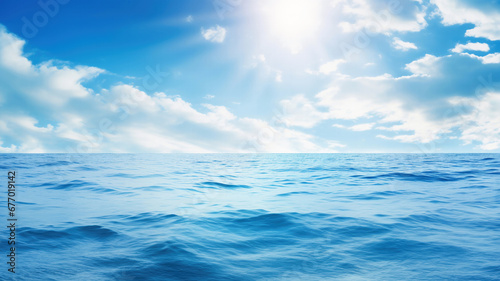 Blue sea water surface and sun on sky background. High quality photo