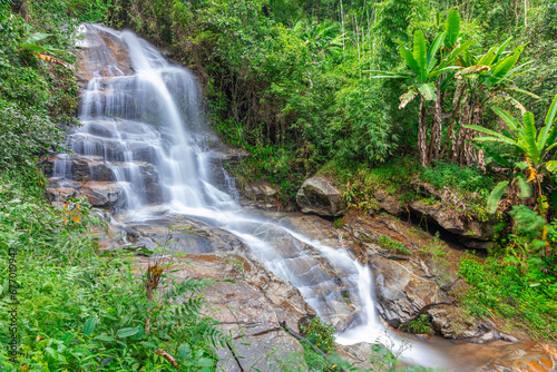 Fototapeta Naklejka Na Ścianę i Meble -  beautiful cascading waterfall over rocks long exposure in Chiangmai Chiang mai mountains northern thailand amongst lush green tropical rainforest