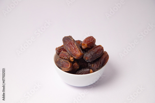 Dates in the white vessel with white background, variety of dates, dates in glass bowl, safawi or Pairom