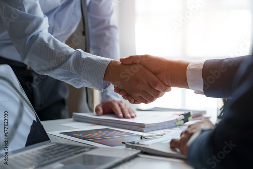 Businessman shaking hands with partner. Greeting. Business joint venture concept. For business finance, investment, teamwork and successful business. photo