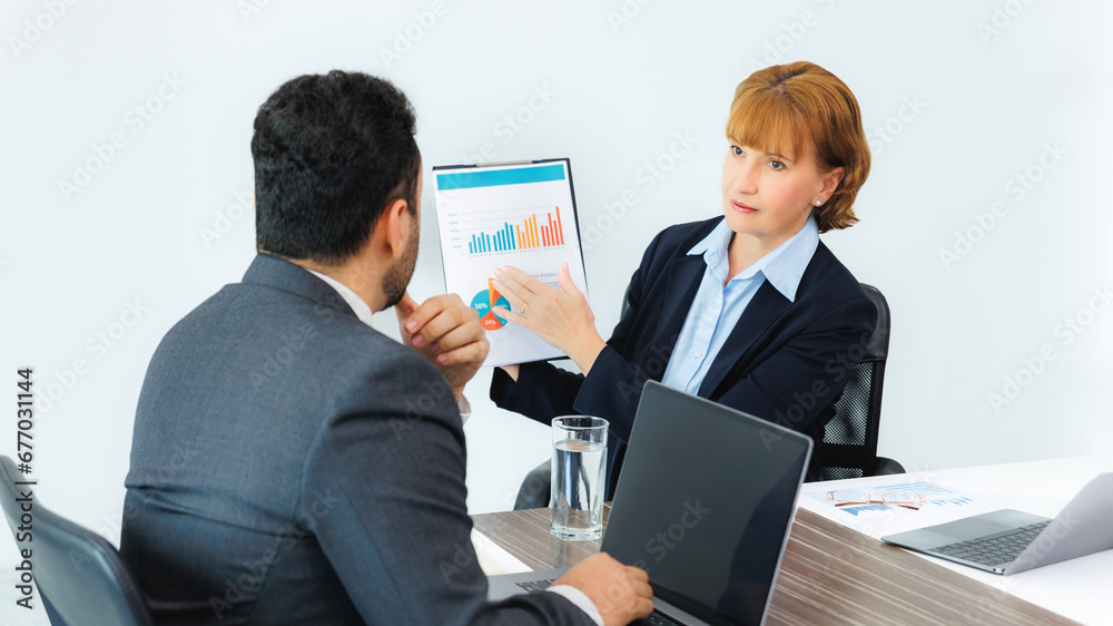 Business woman showing document to business man, professionals discussing papers working in office at meeting. Business woman showing document to business man, professionals discussing papers working in office at meeting.