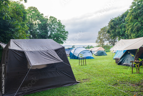 Camping and tent on Lawn or green grass ground in morning, vacation picnic on holiday relax, Camping season.