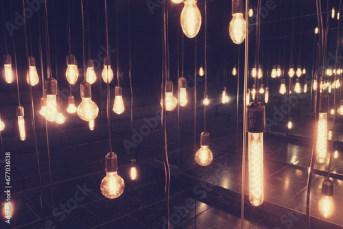 Vintage light bulbs hanging on the ceiling, retro color tone.