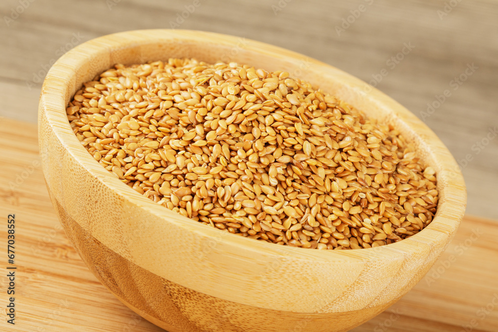 Wooden bowl filled with healthy and delicious Roasted Flax Seeds Wooden bowl filled with healthy and delicious Roasted Flax Seeds