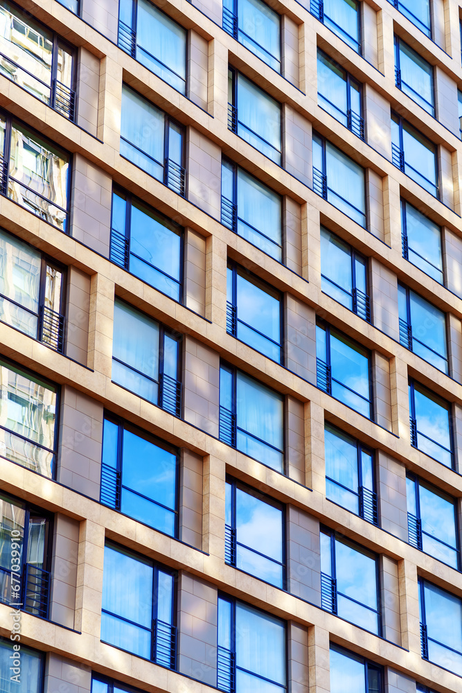 The facade of the building with large windows and false balconies The facade of the building with large windows and false balconies
