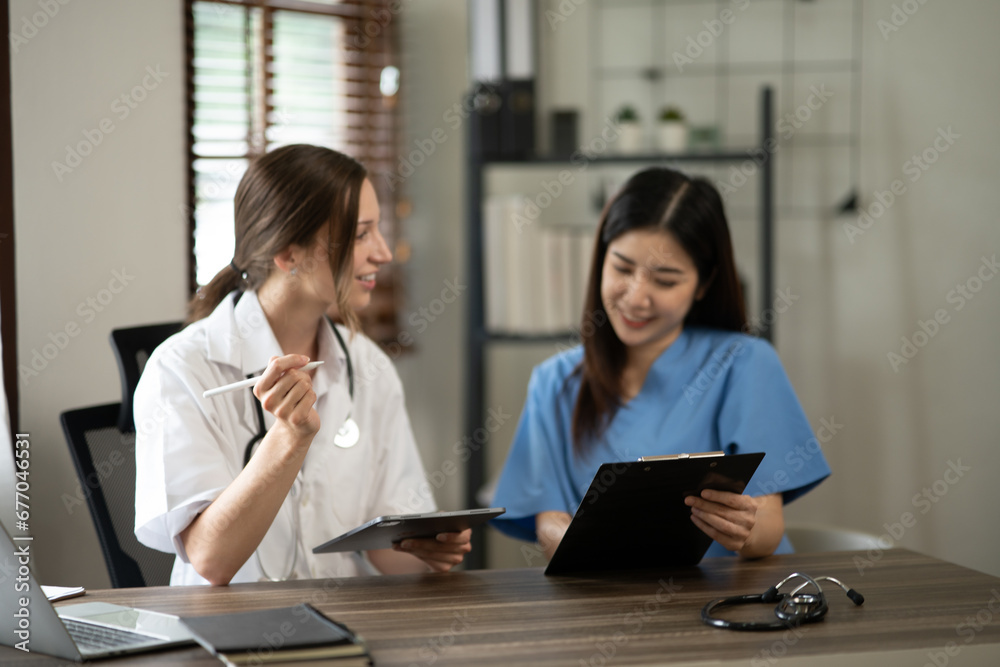 Female doctor sitting at work looking at the history of patients in the clinic or in the hospital Female doctor sitting at work looking at the history of patients in the clinic or in the hospital