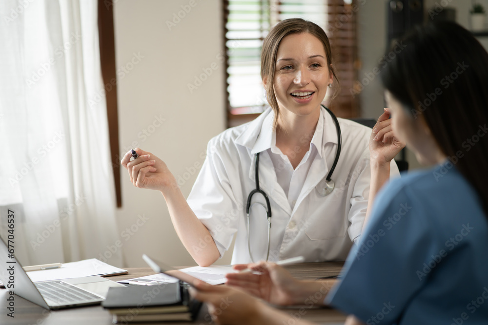 Female doctor sitting at work looking at the history of patients in the clinic or in the hospital Female doctor sitting at work looking at the history of patients in the clinic or in the hospital