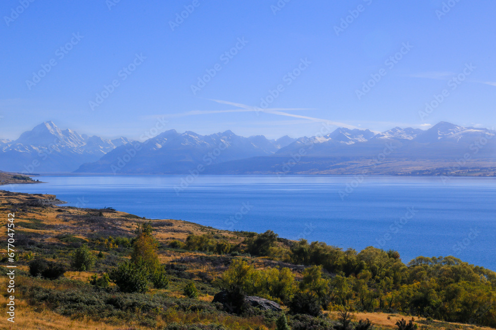 Scenic view of Mount Cook, New Zealand. On the way to Mount Cook nation park at Peter's lookout we can see panoramic view with lake Pukaki and mountain range. Beautiful blue sky with turquoise water.