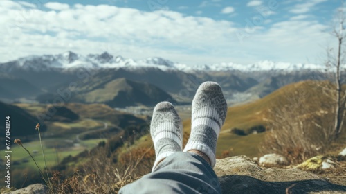 Winter concept, woman's feet with socks on mountain peak, body warmth