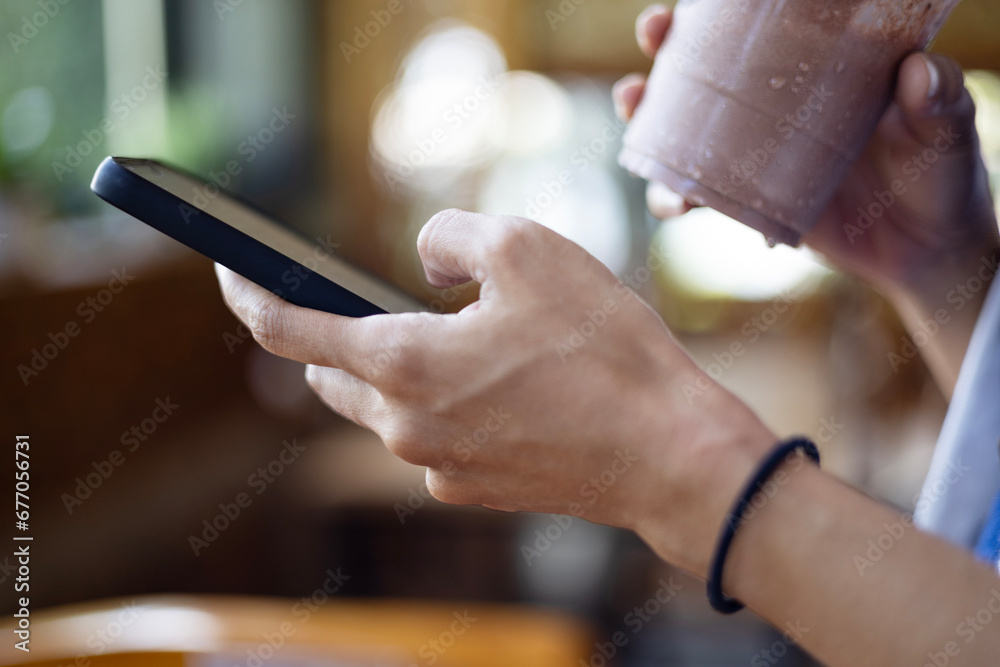 Woman Hand Using Smartphone In Coffee Shop.